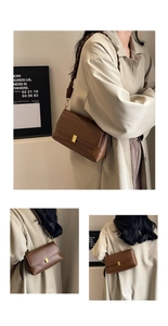 Detail of a brown leather shoulder bag with gold clasp and woven strap on a model