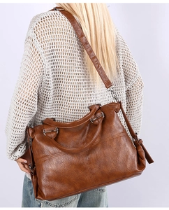 Brown tote bag with vintage pleated texture shown with a detachable shoulder strap