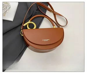 Caramel brown leather box bag size comparison with a smartphone and gold ring handle