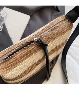 Detail of the high-quality metal zipper and leather puller on a woven striped bucket bag