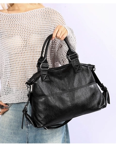 Detail of vintage textured black faux leather tote with adjustable shoulder strap for women