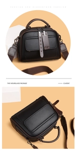 Detail of black lychee grain leather handbag with canvas strap and multi-zipper structure