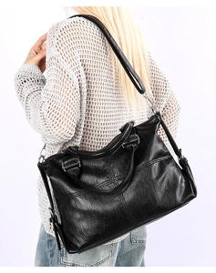 Back view of a black large-capacity tote bag showing the texture and silver hardware