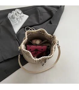 Internal view showing spacious capacity of the pleated bucket bag with inner zip pocket