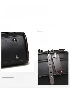 Close-up of black lychee grain leather handbag with dark hardware and protective bottom studs