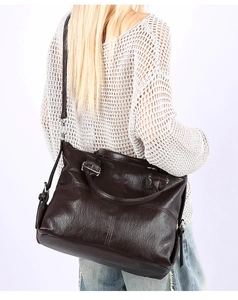 Detail view of large dark brown tote bag with premium lychee texture and metal zippers