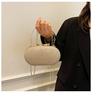 Detail of champagne gold evening clutch with sparkling rhinestones and bow clasp