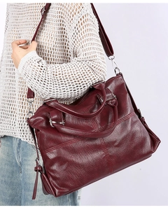 Detail of burgundy large tote bag in oily faux leather with silver adjustable shoulder strap