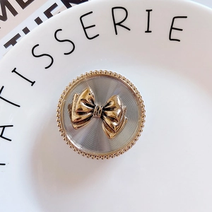 Retro two-tone metal phone pop socket with 3D golden bow and silver sunburst texture