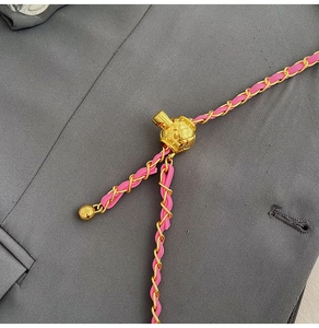 Detailed close-up of pink leather woven chain with adjustable golden ball bead