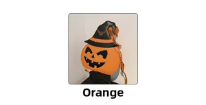 Detail of orange pumpkin bag with black witch hat and gold bat charm for Halloween