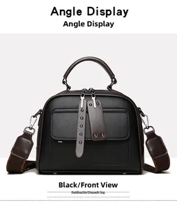 Front view of a black vintage handbag featuring pebbled leather and brown top handles