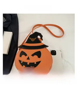Size comparison of pumpkin-shaped Halloween crossbody bag with witch hat and smartphone