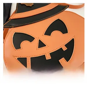 Detail of Halloween pumpkin crossbody bag with stitched witch hat and leather texture