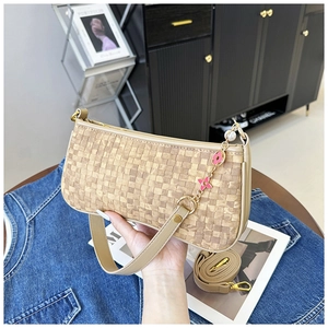 Detail of woven khaki crossbody bag with flower pearl chain and adjustable strap