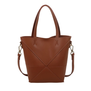 Sac seau marron minimaliste avec coutures en X géométriques et détails dorés