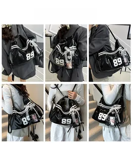 Close-up of black glossy Y2K bag featuring white 89 print and lace bow detail