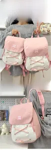 Pink and white patchwork backpack detail with flap design and cross-strap decoration