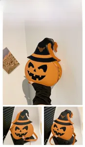 Detail of orange pumpkin crossbody bag with black witch hat and embroidered bat motif