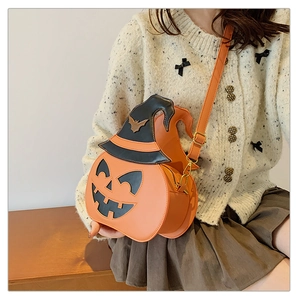 Detailed view of Halloween pumpkin crossbody bag with black witch hat and bat decor