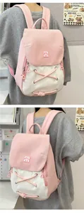 Detail showing the pink and white color-block backpack with adjustable shoulder straps