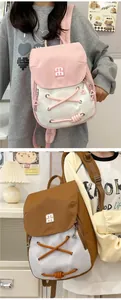 Detail of trendy small backpacks with stylish lace-up design and metal logo for daily use