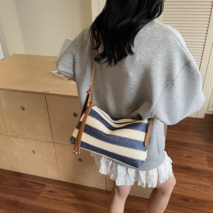 Minimalist navy and beige striped woven shoulder bag with brown leather strap