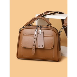 Brown Boston crossbody handbag with wide woven strap and silver rivet accents