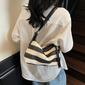 Minimalist black and white striped woven crescent bag with adjustable strap for women