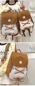 Detail of color-block backpack in two sizes with drawstring decor and side zippers