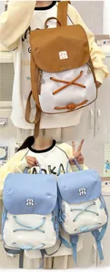 Detail view of stylish color-block mini backpack with decorative criss-cross ropes