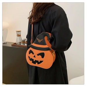 Detail of creative pumpkin crossbody bag with a witch hat and jack-o-lantern face