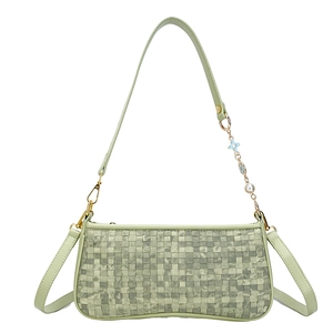 Light green woven pillow bag with decorative floral chain and golden hardware shoulder strap