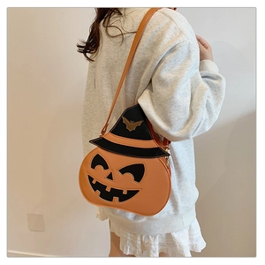 Close-up of Halloween pumpkin shoulder bag with black wizard hat and gold bat patterns