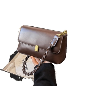 Dark brown leather rectangle shoulder bag with thick woven strap and gold lock buckle