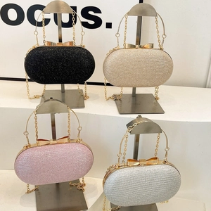 Mini hard shell evening clutch bag with bow clasp and chain strap in multiple colors