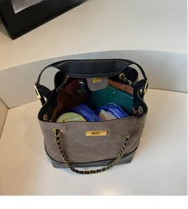 Macro view of the large interior capacity and magnetic closure on the chain bucket bag
