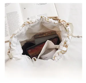 Close-up of woven straw bucket bag showing lace details and spacious inner lining