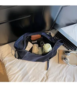 Spacious interior of dark blue denim tote bag with wallet, bottle and umbrella