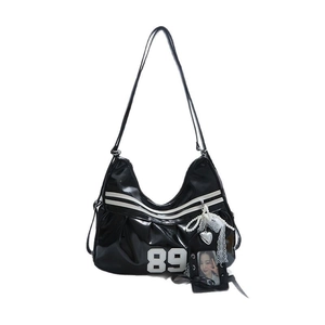 Black patent leather Y2K sports shoulder bag with white number 89 print and charms