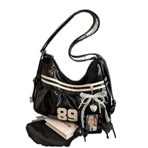 Y2K style black faux leather hobo bag with 89 embroidery, lace bow, and pearl chain