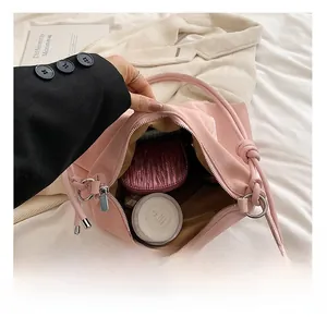 Top-down view of spacious pink tote interior with cosmetics and knotted strap detail