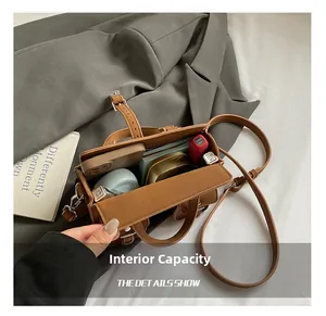 Detailed interior view of a retro brown boston bag showing daily essentials storage