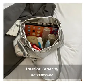 Spacious interior of silver drawstring bucket bag showing high capacity for essentials