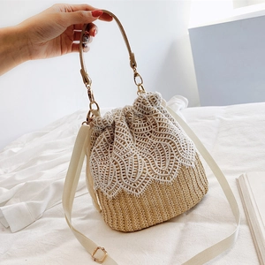 Summer woven bucket bag with white lace floral trim and adjustable shoulder strap