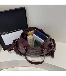 Interior view of large burgundy faux leather tote showing spacious capacity for daily items