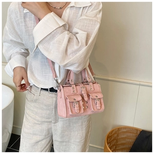 Pink faux leather handbag with cargo pockets shown on model for a trendy summer commute
