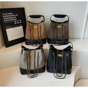 Quilted bucket bags in tan, dark brown, grey and black with chain straps and gold hardware