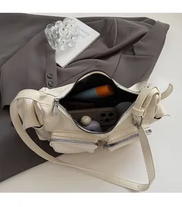 Spacious interior of a beige multi-pocket PU leather crossbody bag with daily essentials
