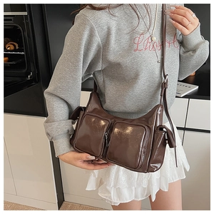 Deep brown vintage faux leather shoulder bag with functional multi-pockets on a model